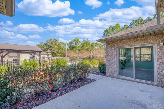 an aerial view of residential house with outdoor space and trees all around