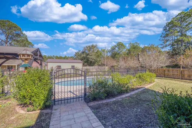 an aerial view of a house with yard swimming pool and outdoor seating
