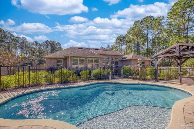 an aerial view of a house with a swimming pool