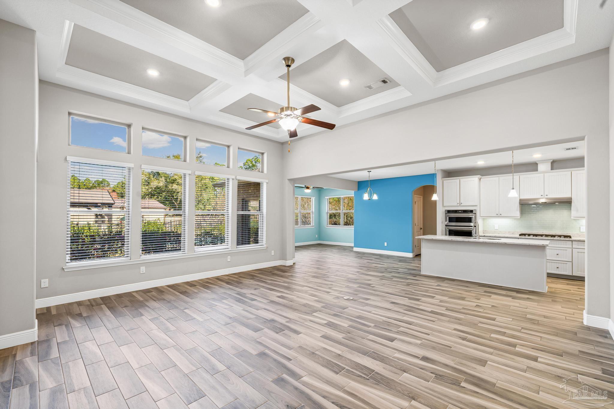 7166 Jasper Street Navarre, FL 32566 - Photo 5 of 71 a view of empty room with wooden floor and fan