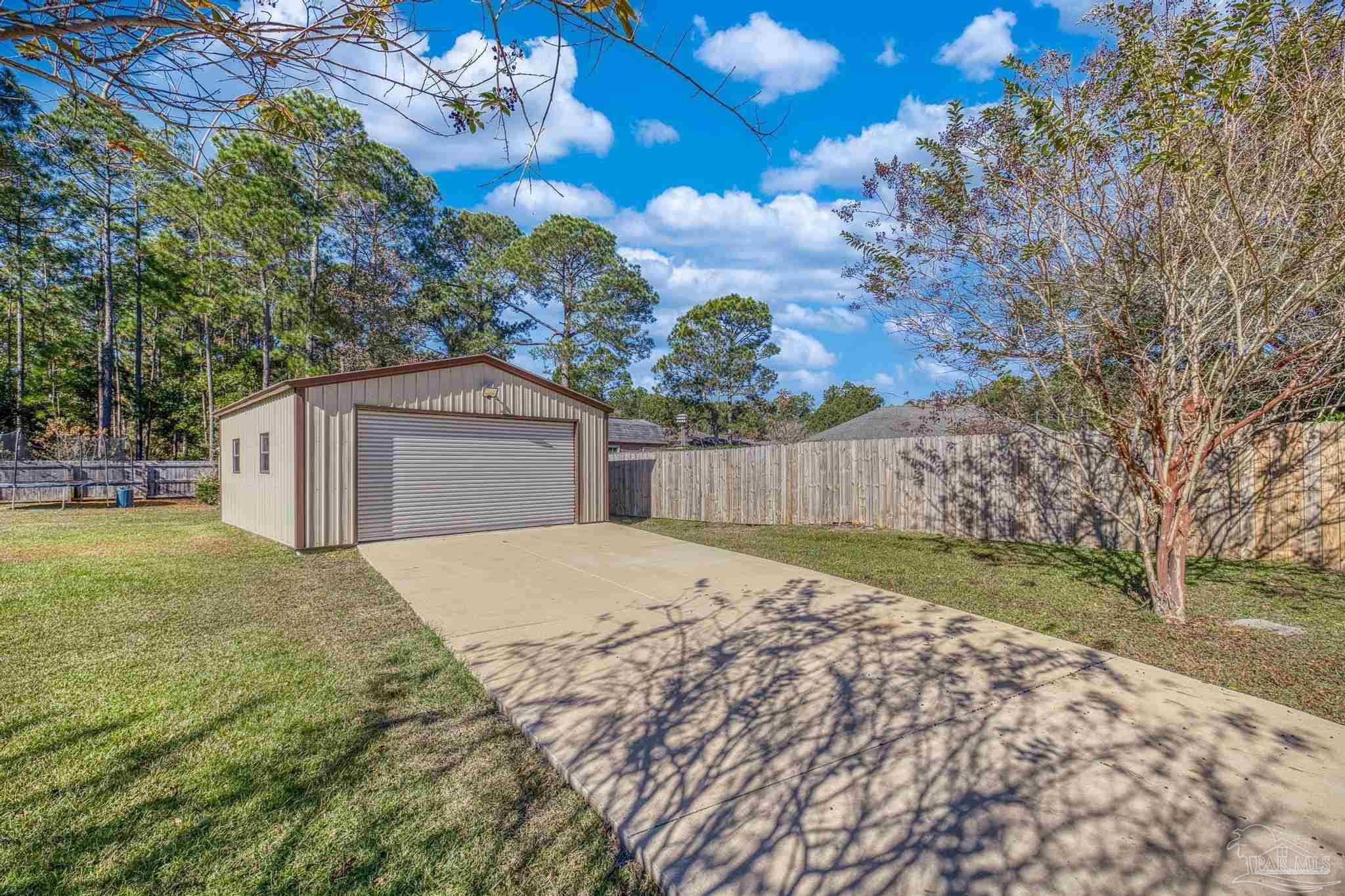 7166 Jasper Street Navarre, FL 32566 - Photo 51 of 71 a house view with a garden space
