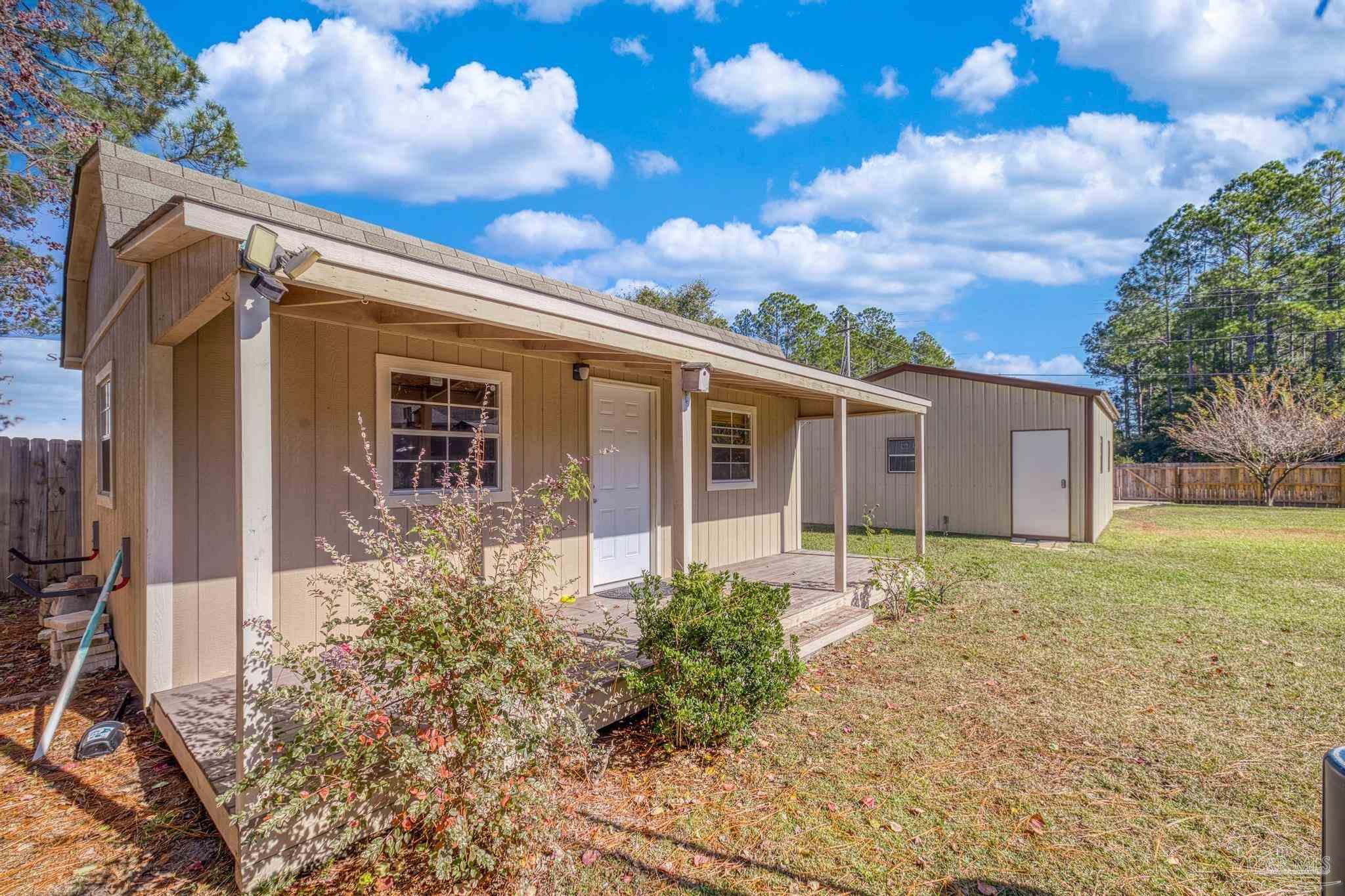 7166 Jasper Street Navarre, FL 32566 - Photo 57 of 71 a view of a house with a yard