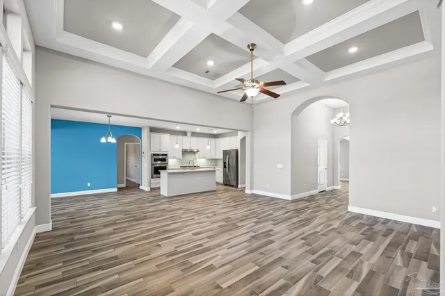 a view of a kitchen with a sink and dishwasher with wooden floor