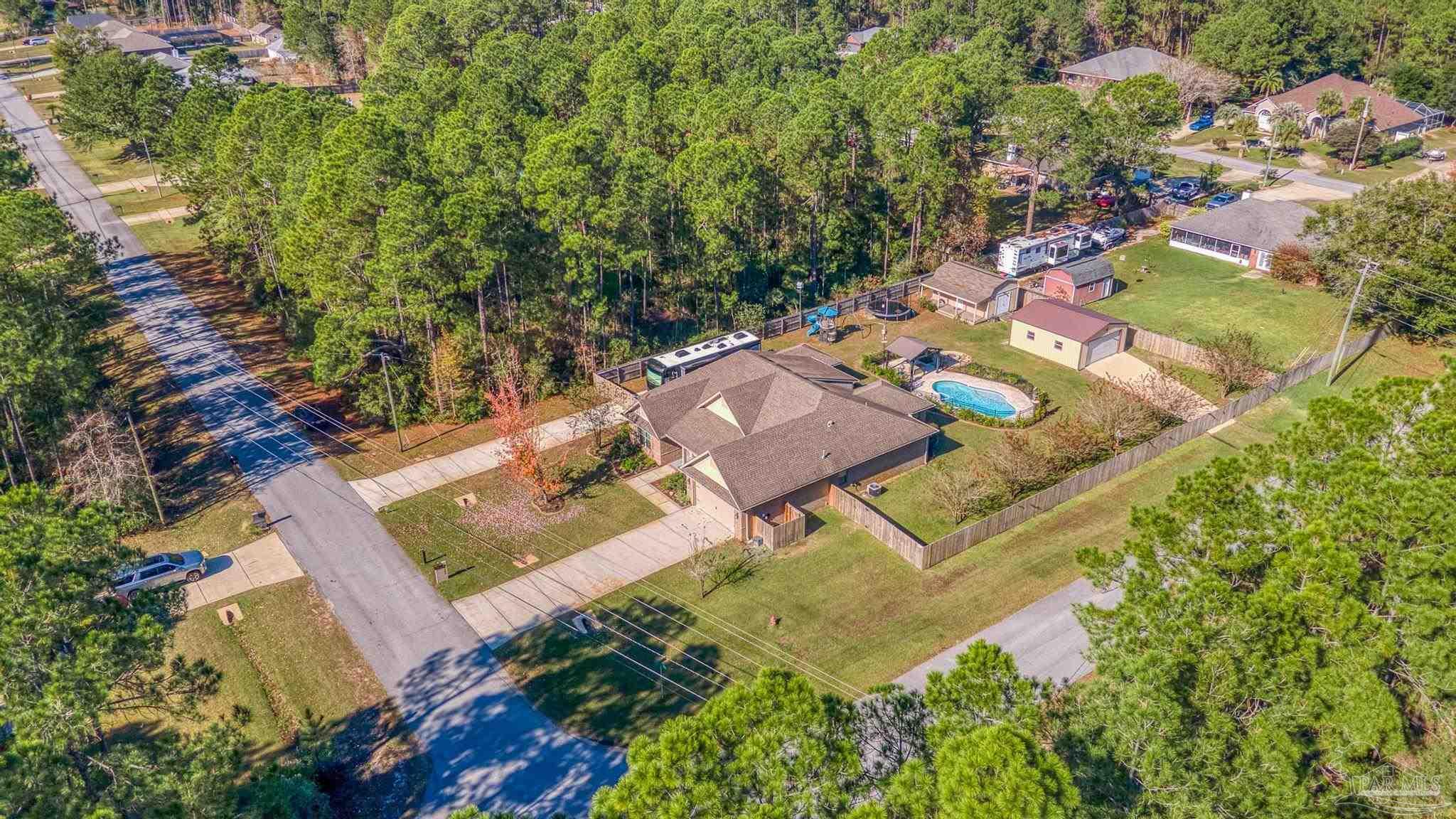 7166 Jasper Street Navarre, FL 32566 - Photo 67 of 71 an aerial view of a house with a swimming pool