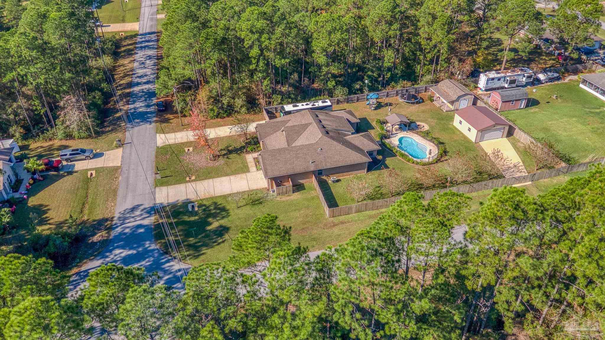 7166 Jasper Street Navarre, FL 32566 - Photo 68 of 71 an aerial view of a house with yard swimming pool and outdoor seating