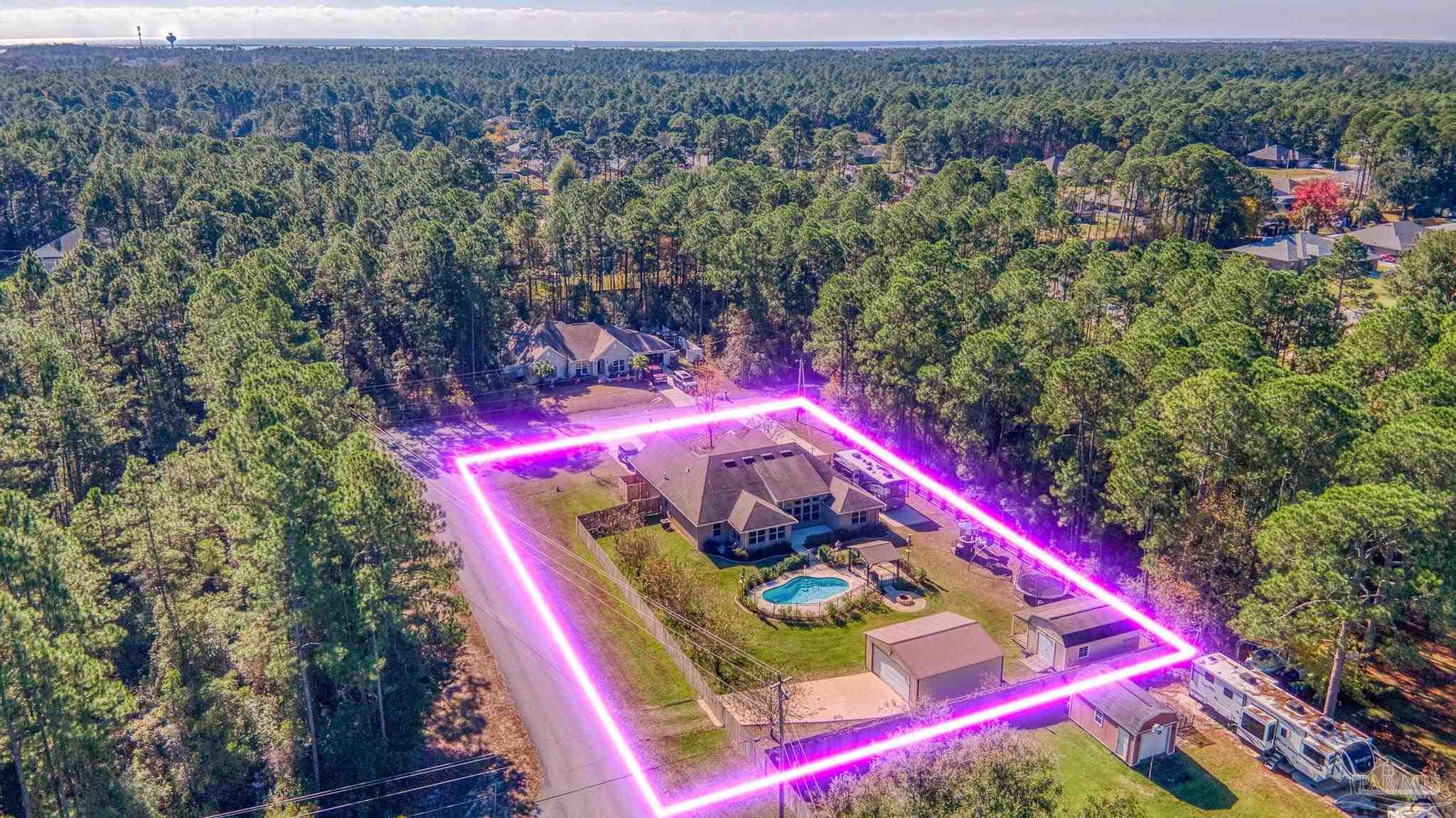 7166 Jasper Street Navarre, FL 32566 - Photo 70 of 71 an aerial view of a houses with a yard