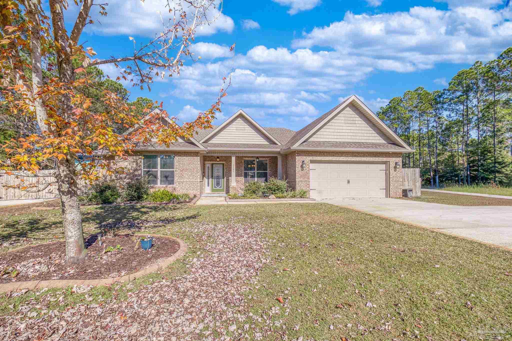 7166 Jasper Street Navarre, FL 32566 - Photo 71 of 71 a front view of a house with a yard