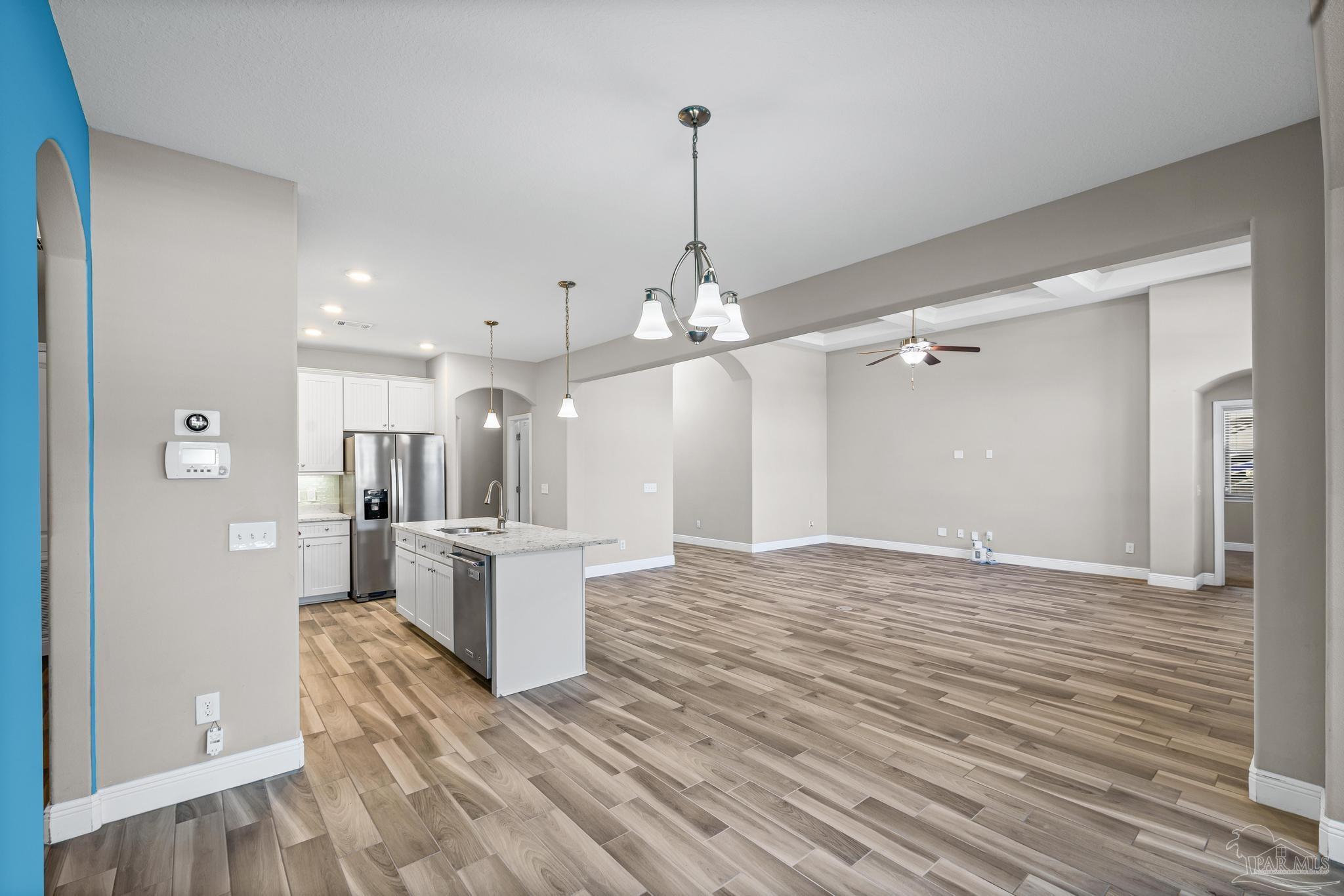 7166 Jasper Street Navarre, FL 32566 - Photo 9 of 71 a view of a kitchen with a sink and dishwasher with wooden floor