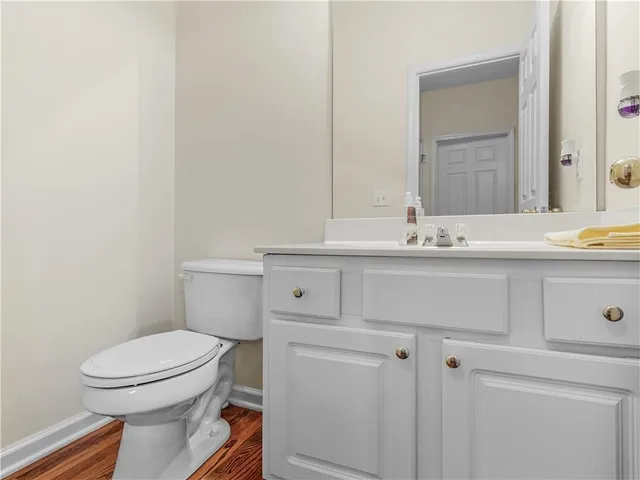 a bathroom with a sink mirror vanity and toilet
