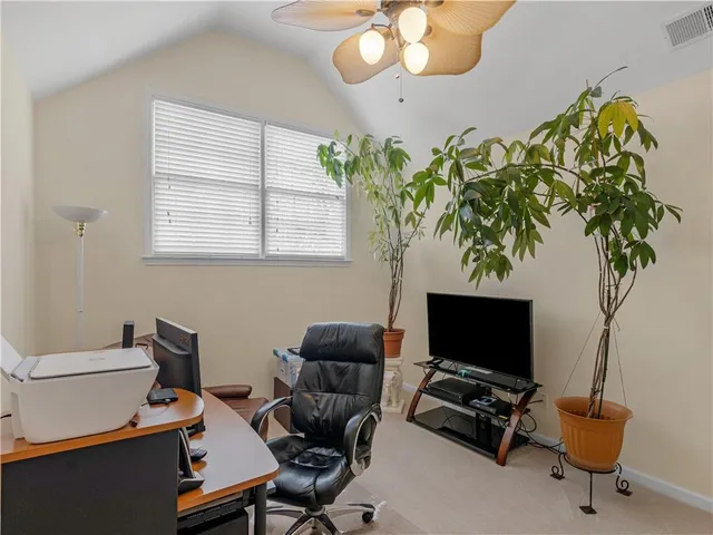 a living room with furniture a chandelier and a flat screen tv