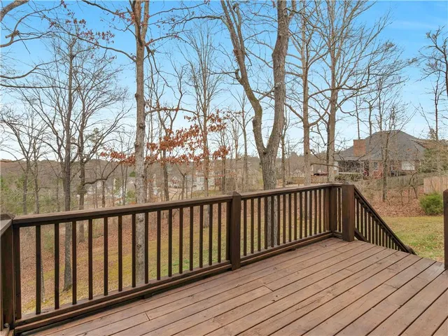 a view of balcony with wooden floor and fence
