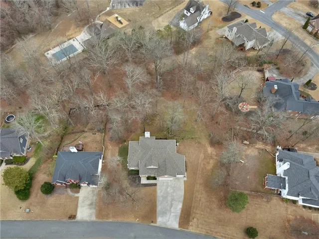 an aerial view of a house with a yard