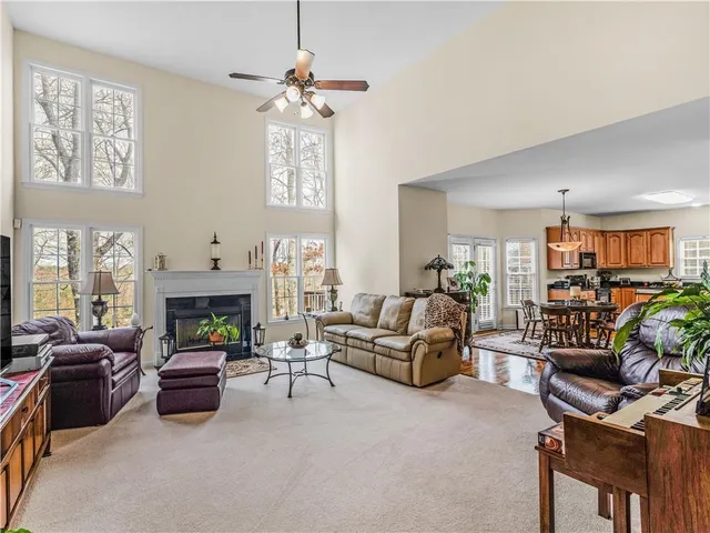 a living room with furniture a fireplace and a window