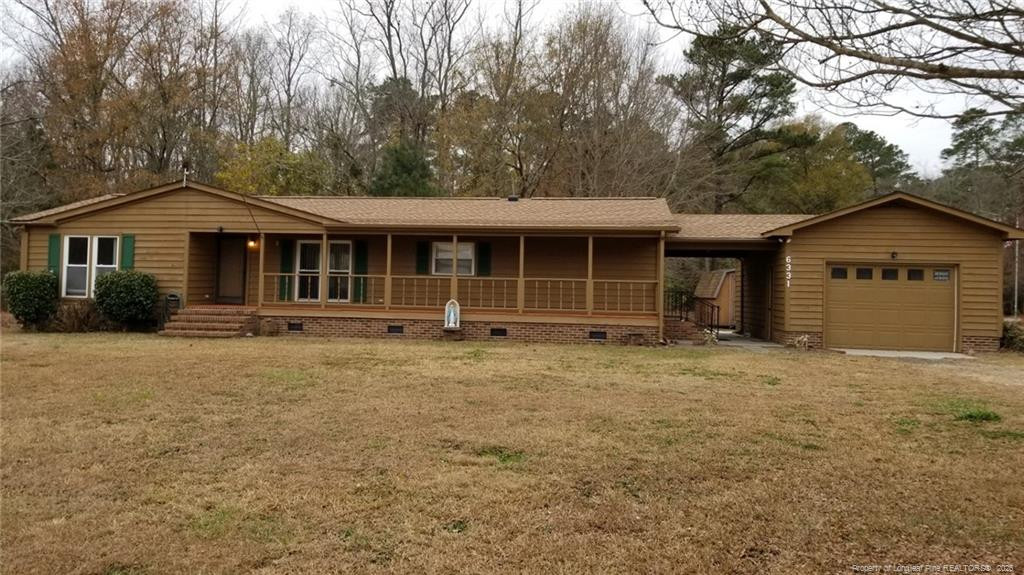 6331 Rennert Road Shannon, NC 28386 - Photo 1 of 4 a front view of a house with a garden