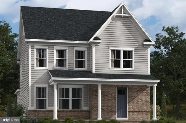 a view of a house with large windows and a tree