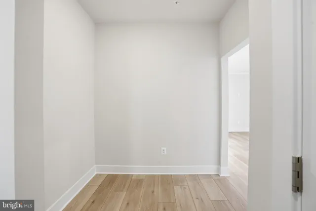 a view of a room with wooden floor