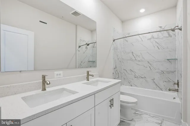 a bathroom with a sink a toilet and a bathtub