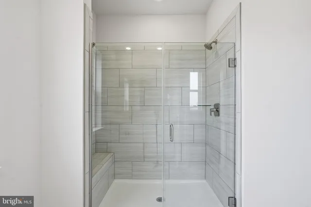 a bathroom with a shower and a sink