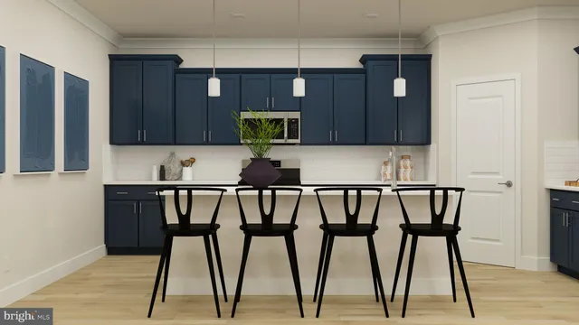 a kitchen with a table chairs and cabinets