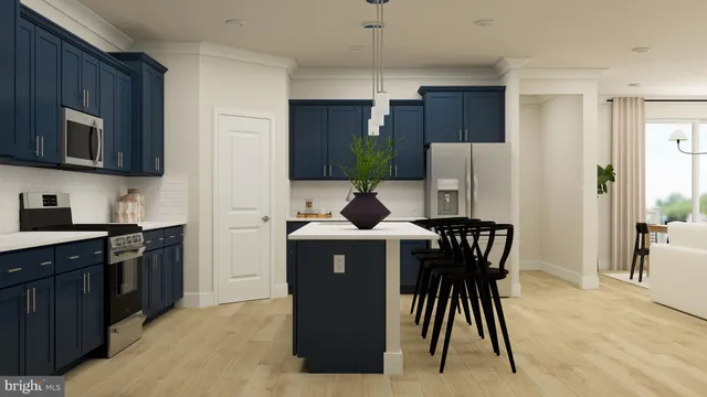 a kitchen with stainless steel appliances a table chairs refrigerator and microwave