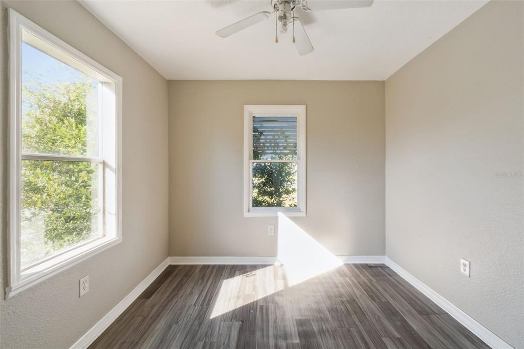 40542 West 3rd Avenue Umatilla, FL 32784 - Photo 6 of 13 a view of an empty room with wooden floor and a window