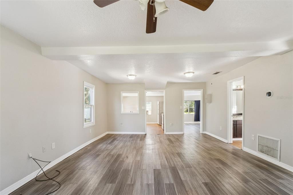 40542 West 3rd Avenue Umatilla, FL 32784 - Photo 8 of 13 wooden floor in an empty room with a window