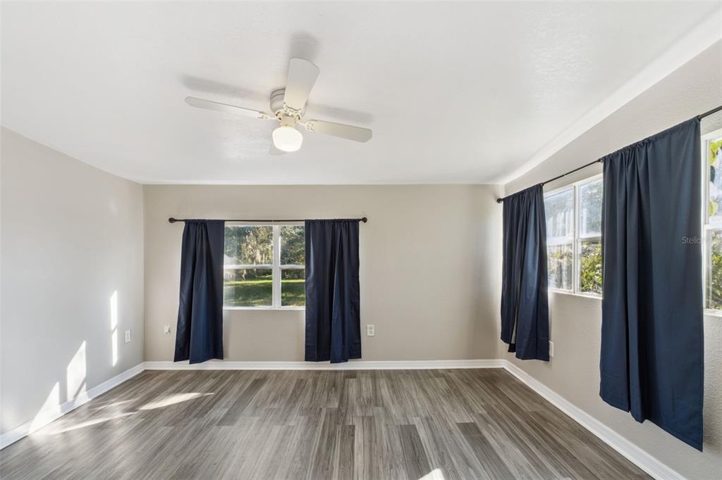 40542 West 3rd Avenue Umatilla, FL 32784 - Photo 9 of 13 wooden floor in an empty room with a window