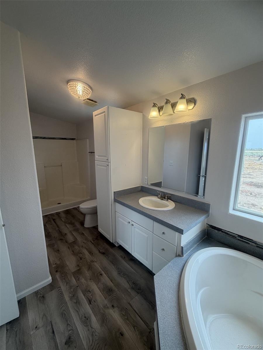 5511 Ridgetop Court Alamosa, CO 81101 - Photo 9 of 10 a bathroom with a granite countertop sink and a mirror