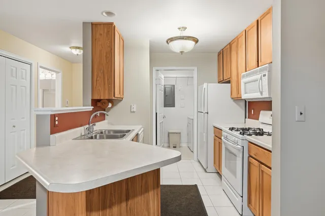 a kitchen with a stove a refrigerator and a sink