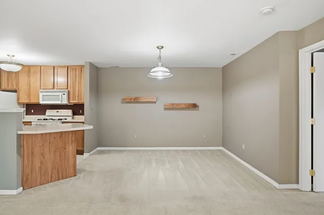 a kitchen with a refrigerator a stove a sink and a window