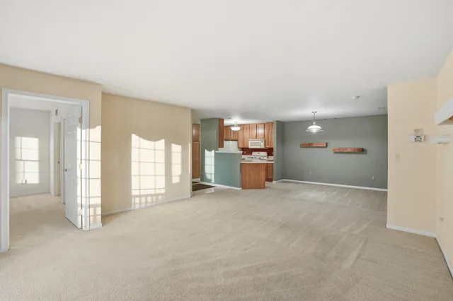 an empty room with furniture and windows