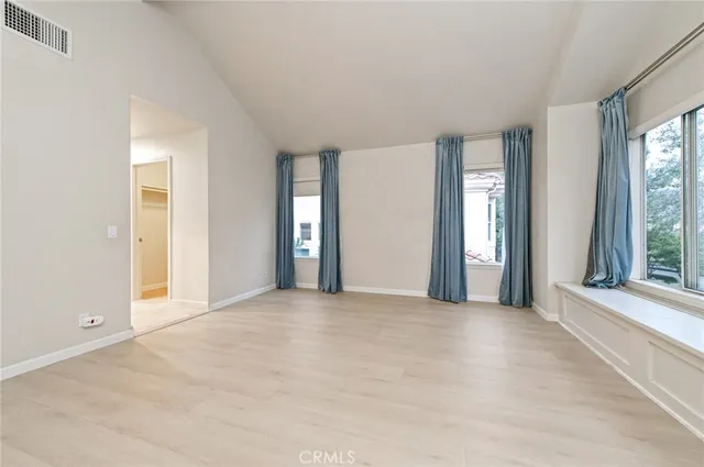 a view of an empty room with large windows