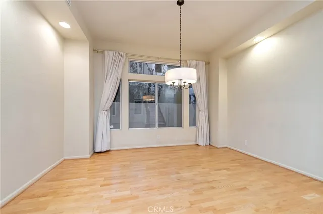 a view of empty room with a ceiling fan and window