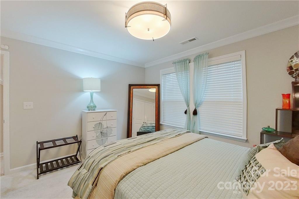 511 Upper Stone Circle Charlotte, NC 28211 - Photo 15 of 32 a bedroom with a bed and a chandelier