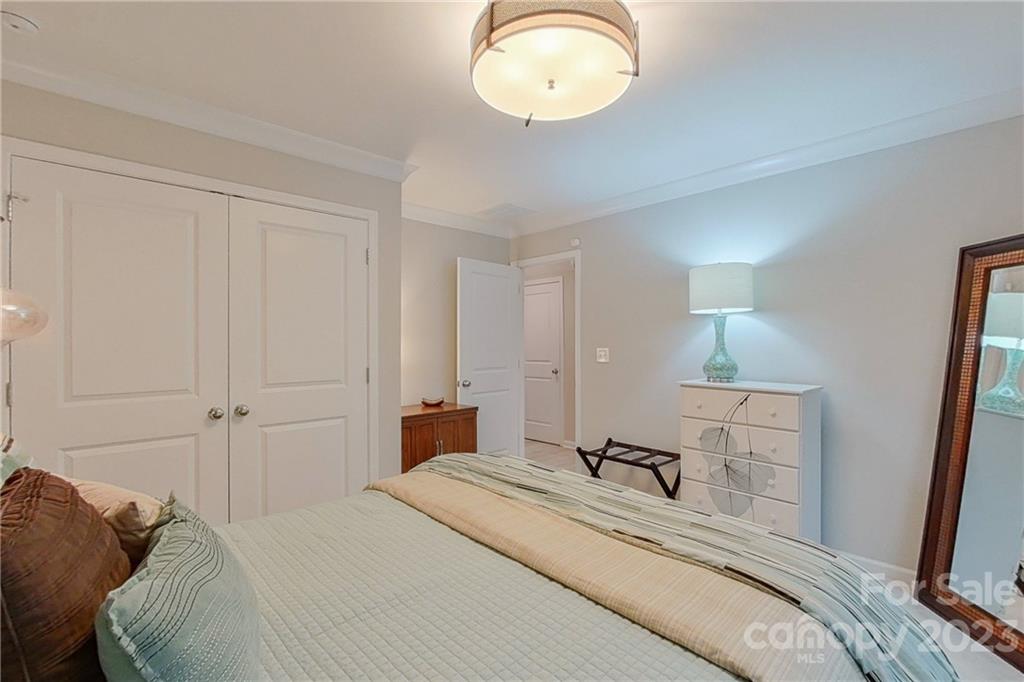 511 Upper Stone Circle Charlotte, NC 28211 - Photo 16 of 32 a bedroom with a bed and a mirror