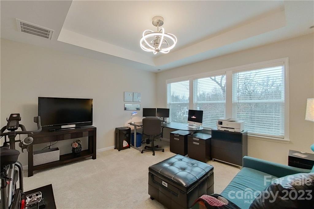 511 Upper Stone Circle Charlotte, NC 28211 - Photo 21 of 32 a view of a livingroom with workspace and a window