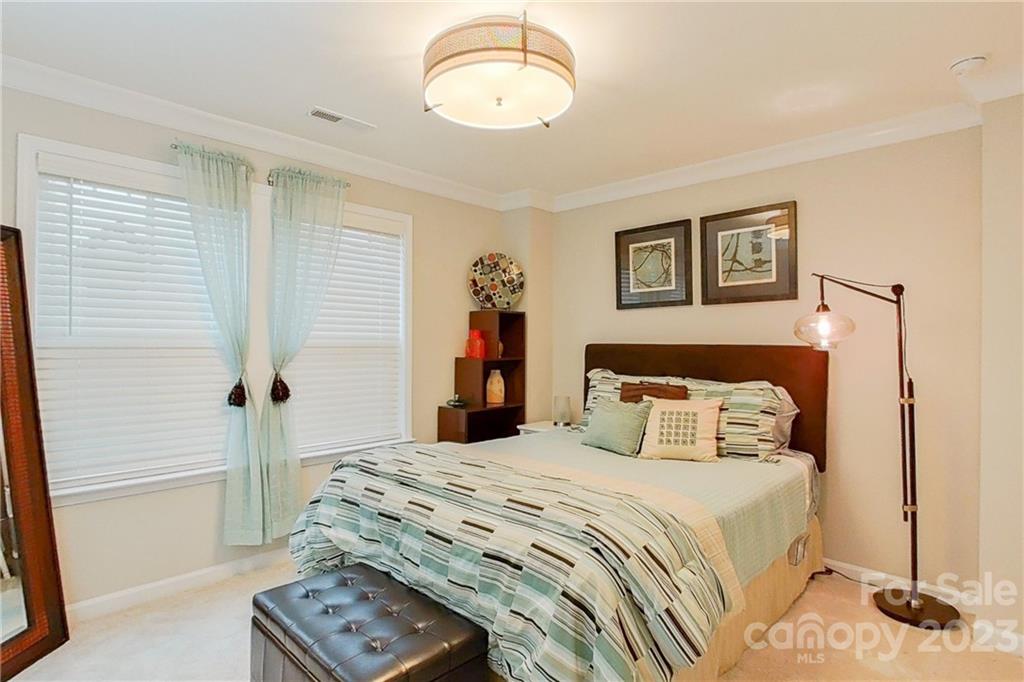 511 Upper Stone Circle Charlotte, NC 28211 - Photo 28 of 32 a bedroom with a bed and a table