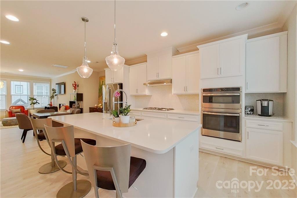 511 Upper Stone Circle Charlotte, NC 28211 - Photo 7 of 32 a kitchen with a stove a refrigerator and white cabinets