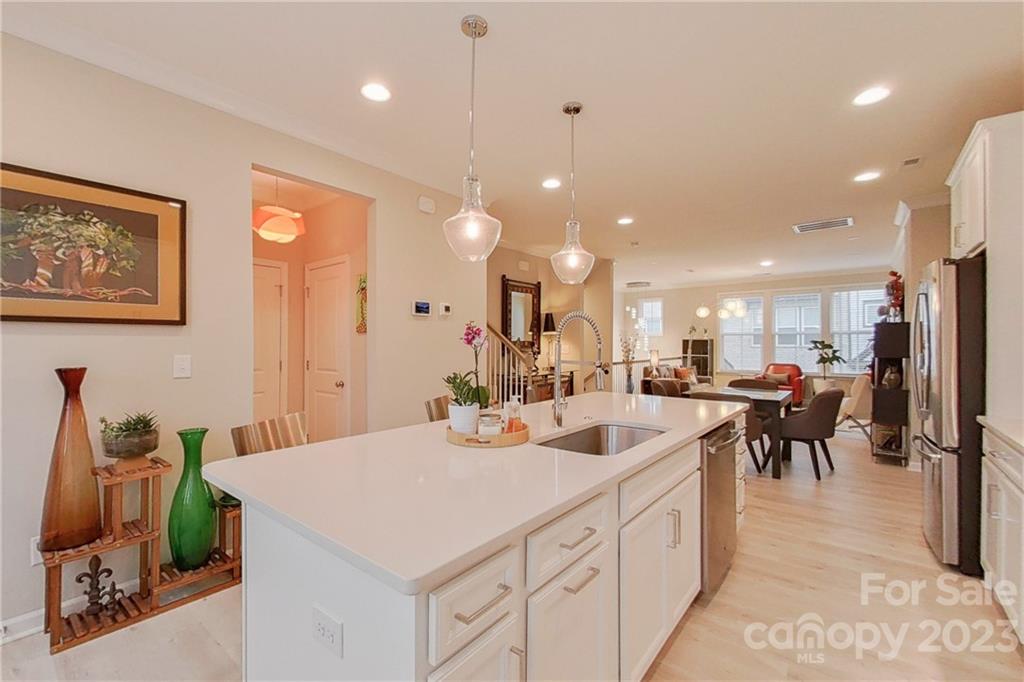 511 Upper Stone Circle Charlotte, NC 28211 - Photo 8 of 32 a large kitchen with kitchen island a sink table and chairs