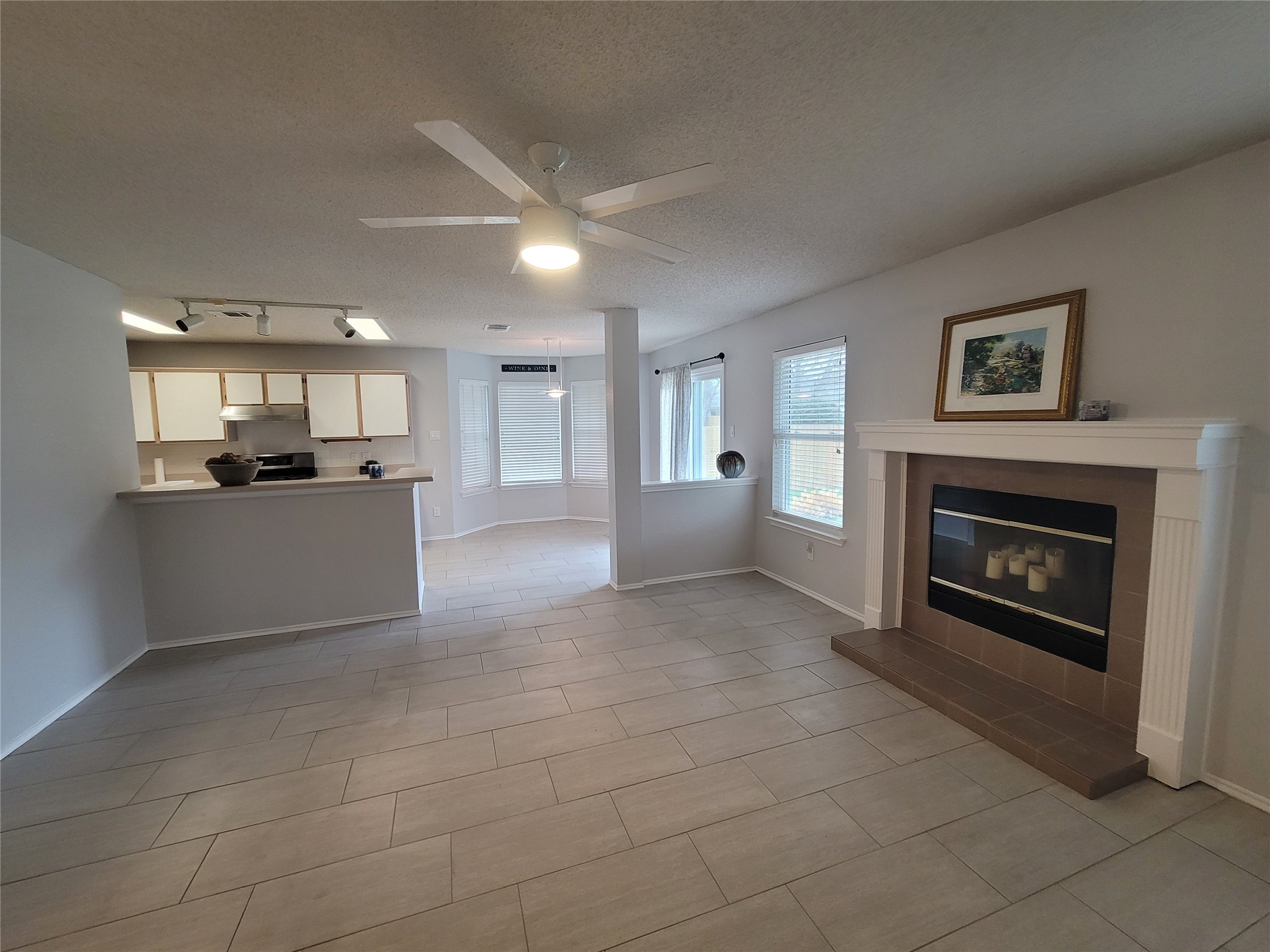 1805 Timber Ridge Drive Cedar Park, TX 78613 - Photo 4 of 21 a view of a kitchen and an empty room with a fireplace