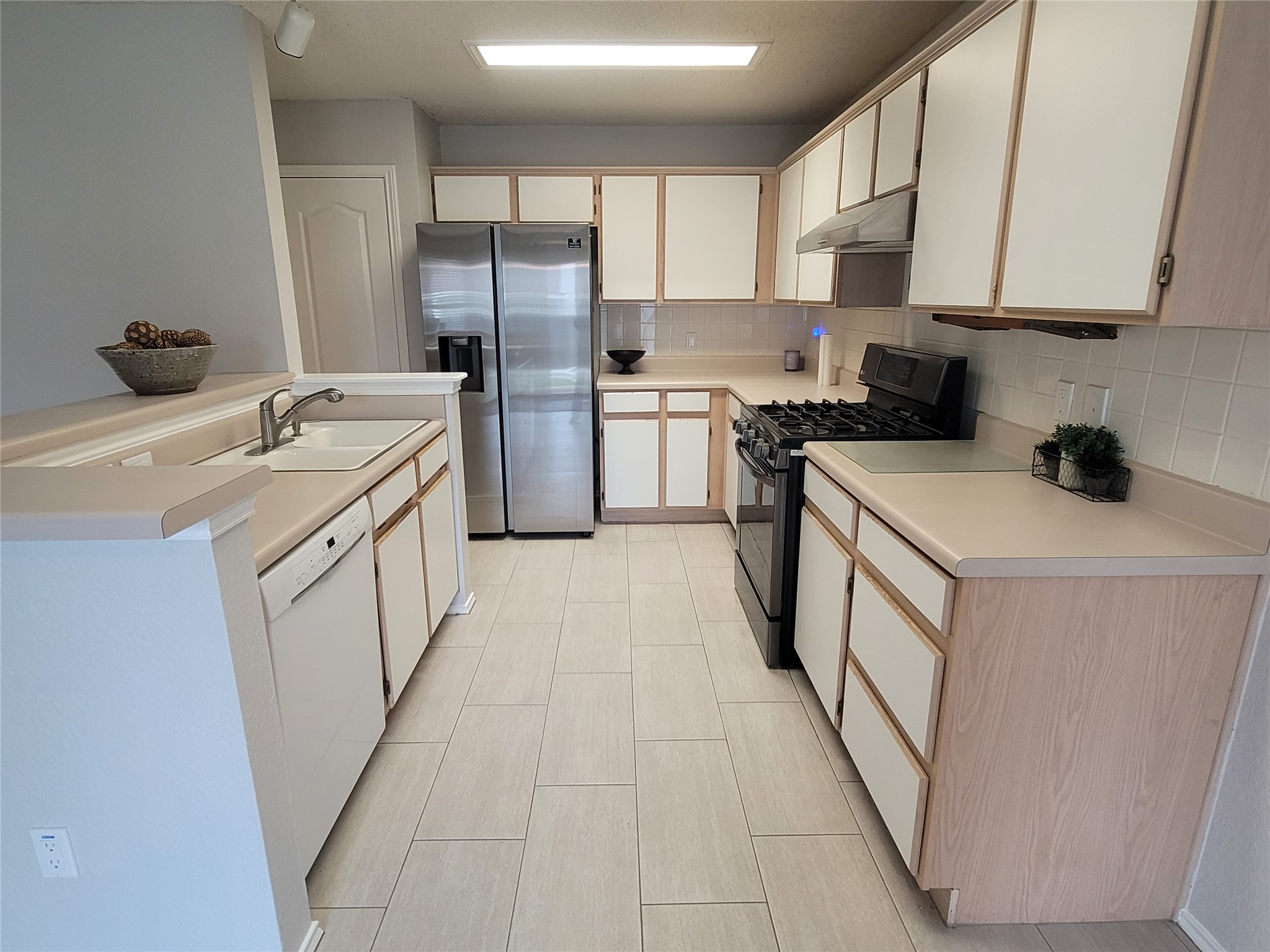 1805 Timber Ridge Drive Cedar Park, TX 78613 - Photo 5 of 21 a kitchen with white cabinets a sink and appliances