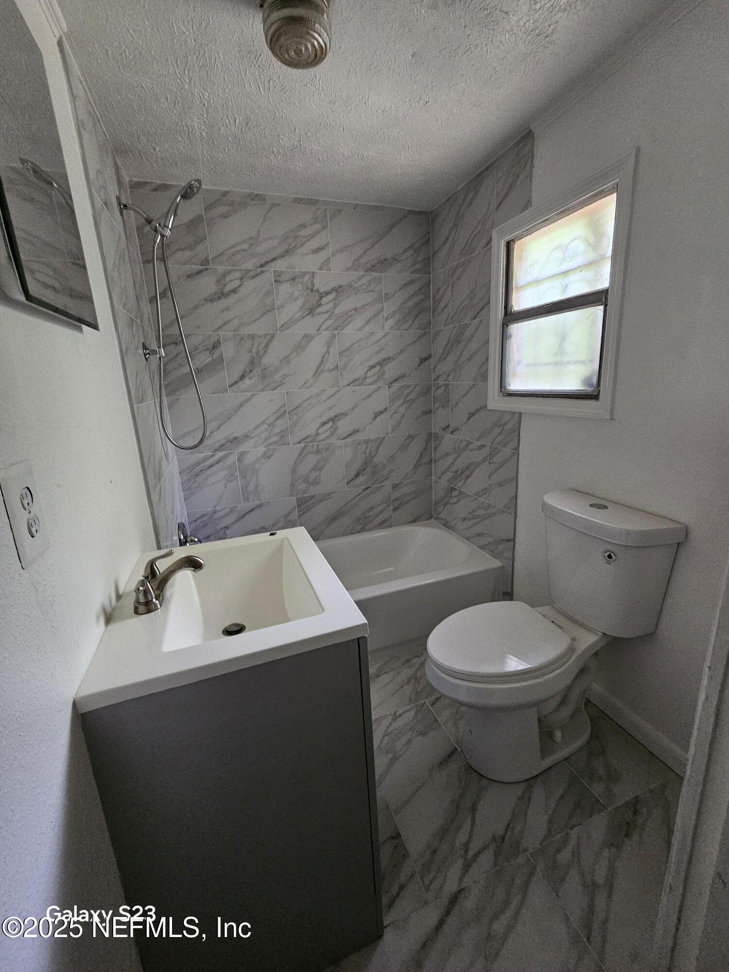 6526 Ribault Road Jacksonville, FL 32209 - Photo 11 of 13 a bathroom with a sink a toilet and bathtub