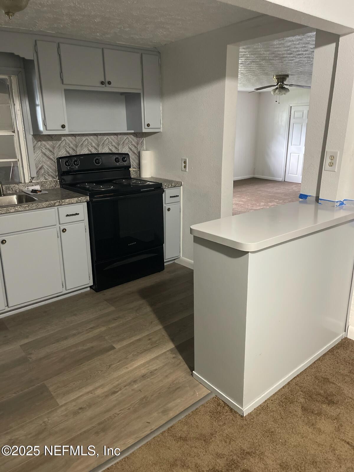 6526 Ribault Road Jacksonville, FL 32209 - Photo 4 of 13 a kitchen with a stove and a refrigerator