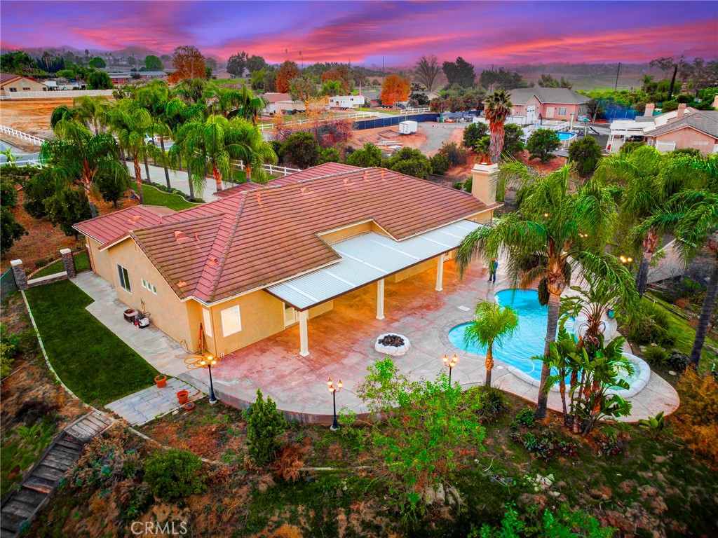 18120 Gentian Avenue Riverside, CA 92508 - Photo 12 of 51 a view of a swimming pool with a table and chairs