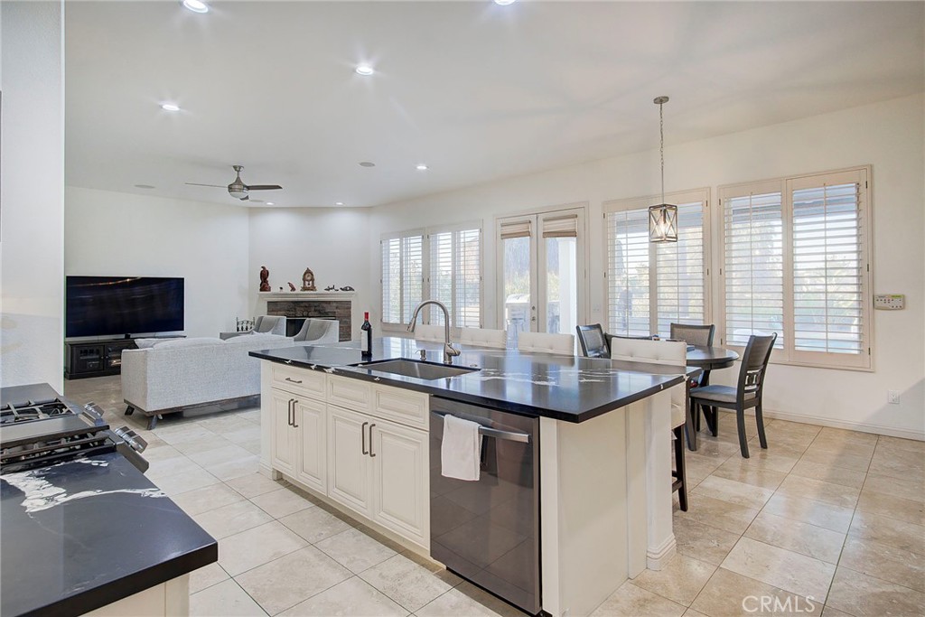 18120 Gentian Avenue Riverside, CA 92508 - Photo 30 of 51 a kitchen with sink stove and chairs