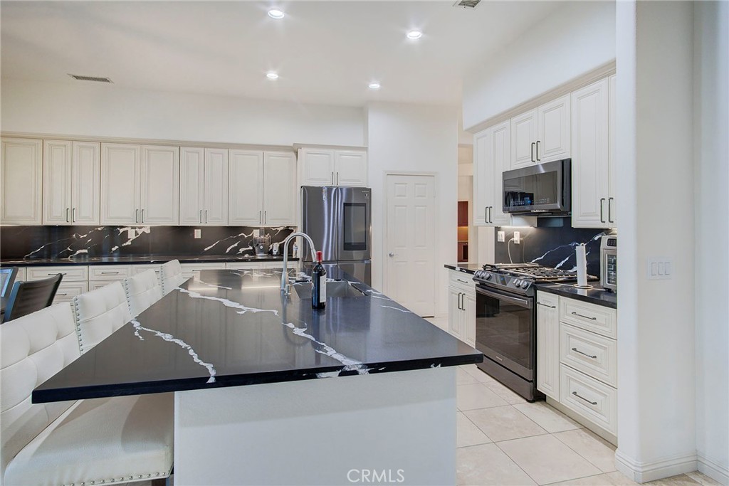 18120 Gentian Avenue Riverside, CA 92508 - Photo 32 of 51 a kitchen with a sink stove and refrigerator