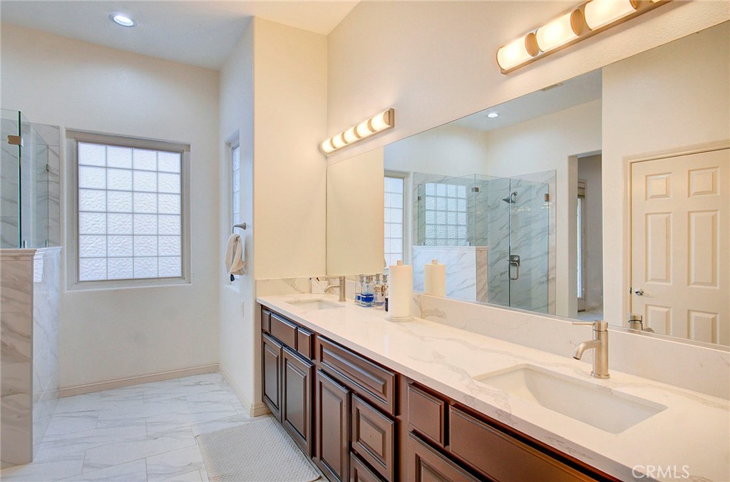 18120 Gentian Avenue Riverside, CA 92508 - Photo 38 of 51 a bathroom with a sink double vanity and a bathtub