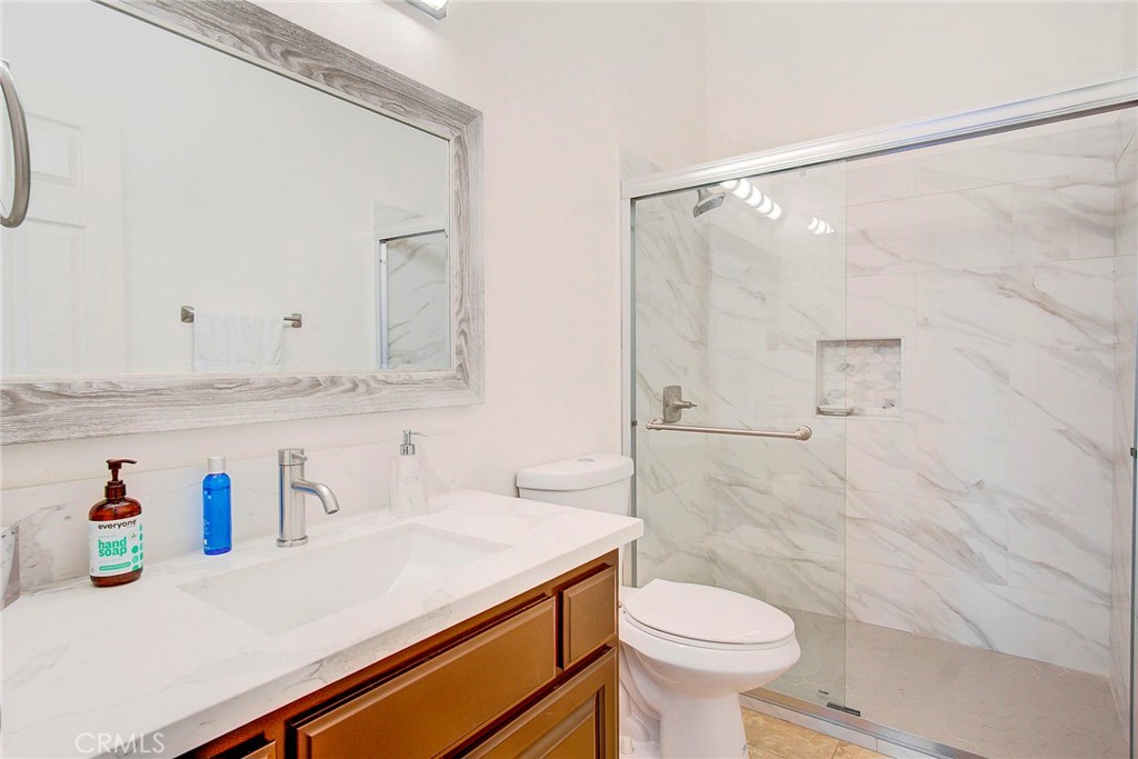 18120 Gentian Avenue Riverside, CA 92508 - Photo 40 of 51 a bathroom with a sink a toilet and a shower