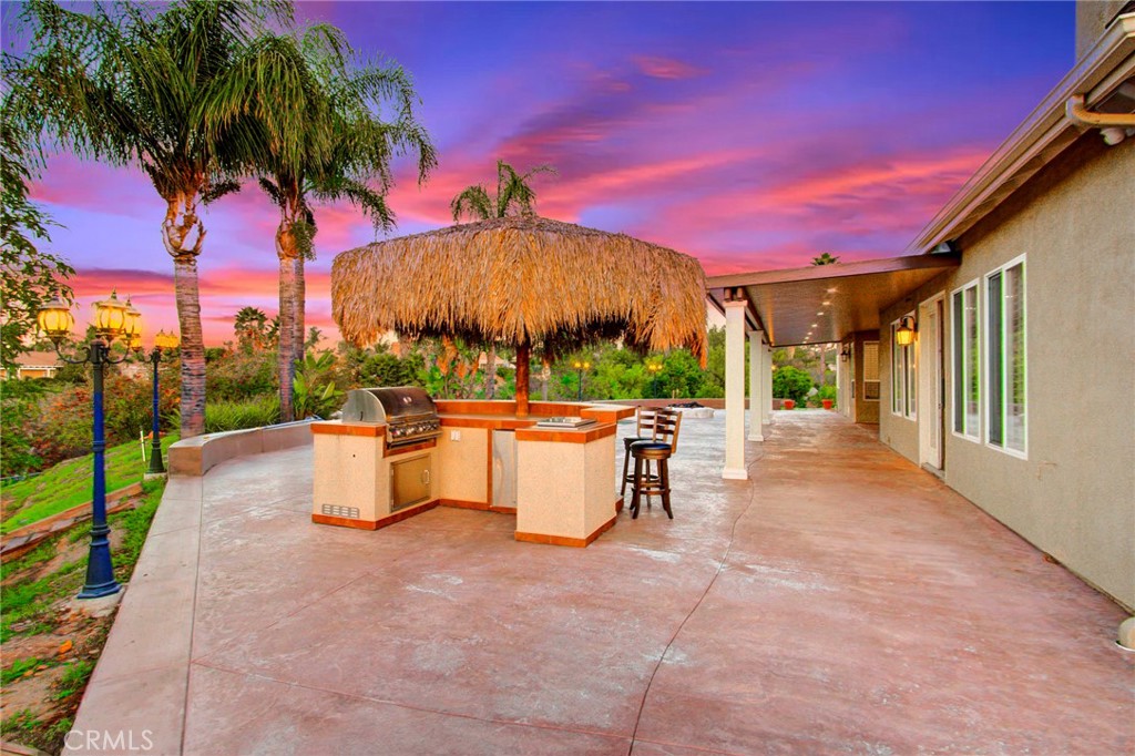 18120 Gentian Avenue Riverside, CA 92508 - Photo 46 of 51 a view of a patio with couches and table and chairs with wooden fence and floor