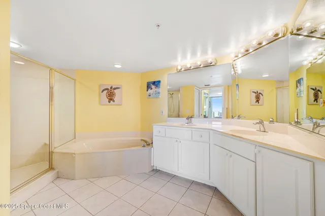 a bathroom with a bathtub a sink and a shower